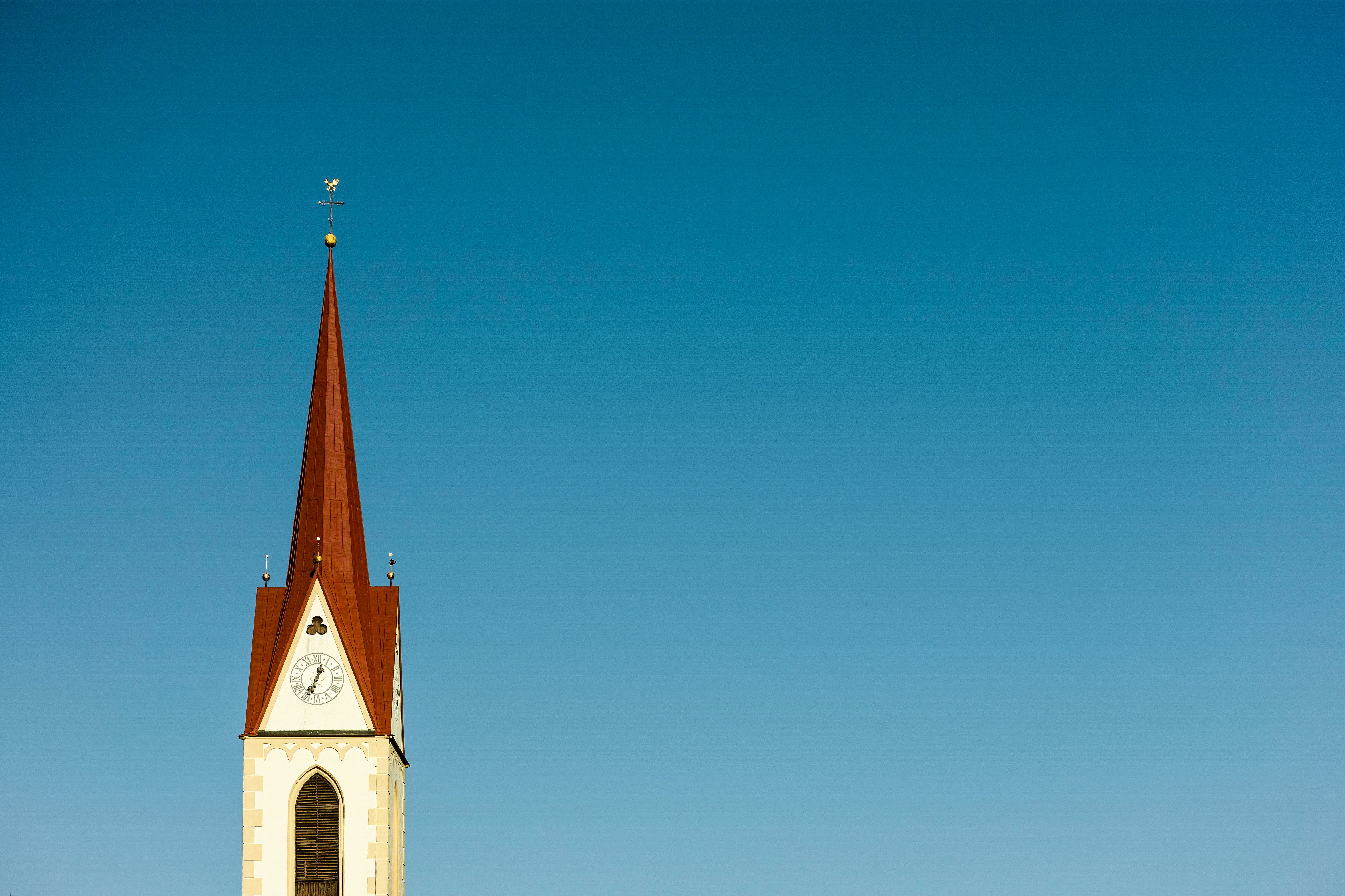 white and red cathedral under blue sky